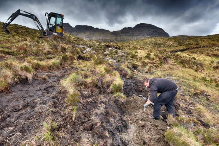 Andy shovelling gravel. Photo © Chris Puddephatt