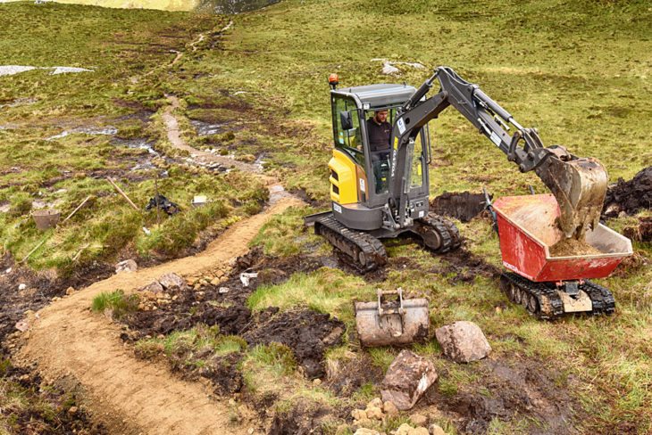 Andy in the digger and the path snaking back. Photo © Chris Puddephatt