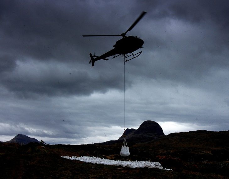 A bag of gravel being airlifted during a lull. Photo © Chris Goodman.