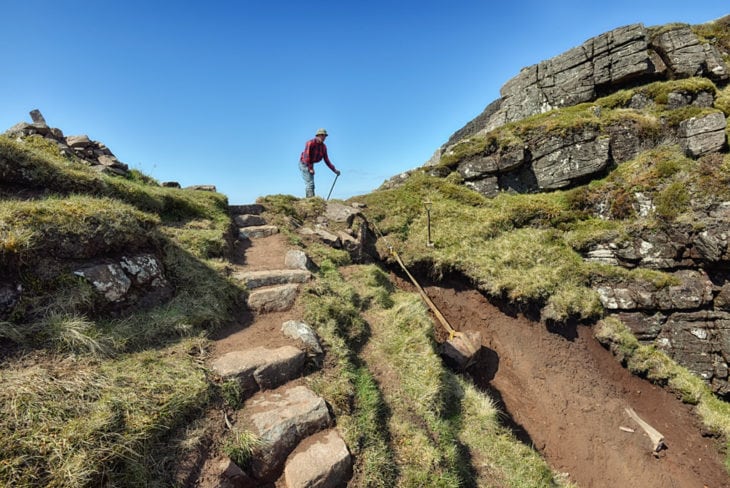 Johny winching stone down the gully on the ridge of Suilven. Photo © Chris Puddephatt