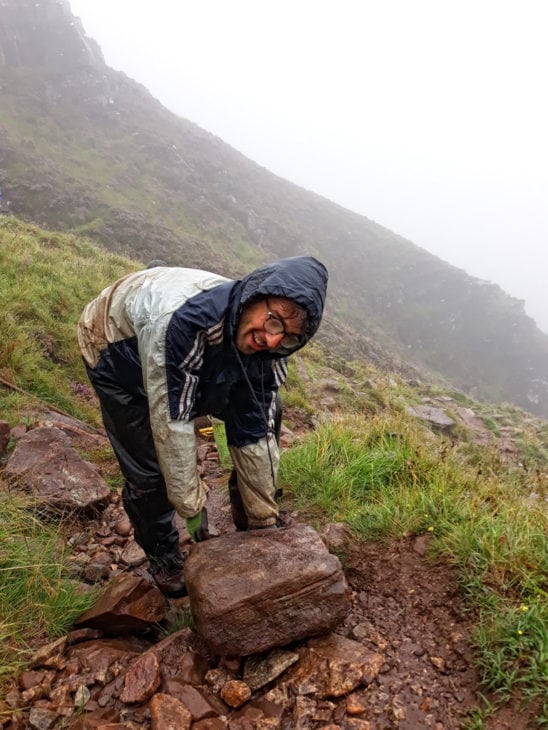 Ewan manoeuvres a big stone into position. Photo © Chris Puddephatt.