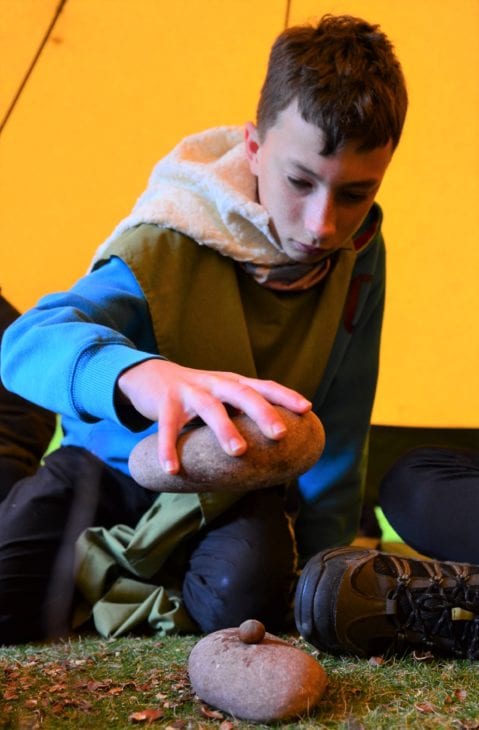 Breaking into hazelnuts the traditional way in the shelter of the Mock Broch © Katrina Martin/Scottish Wildlife Trust